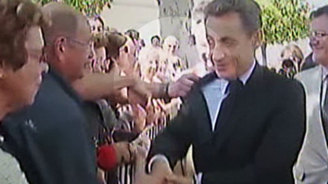 Sarkozy scuffle during handshake tour