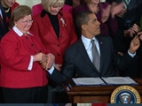 Obama Signs First Bill