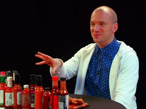Hot Ones - Superfan Brett Baker Grills Sean Evans Over Spicy Wings