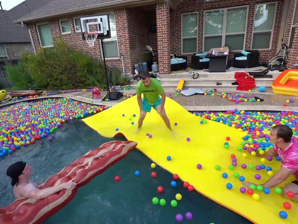 Unspeakable - The Biggest Backyard Water Slide Challenge / Last to Leave the Pool Wins $10,000!