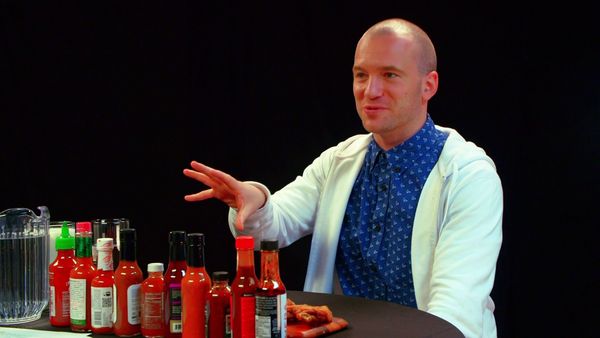 Hot Ones - Superfan Brett Baker Grills Sean Evans Over Spicy Wings