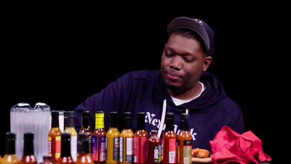 Hot Ones - Michael Che Gs Up While Eating Spicy Wings
